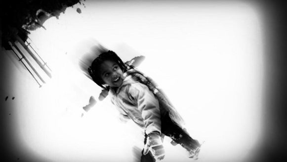 Azora cocking back her arm to throw her first snowball - ever!